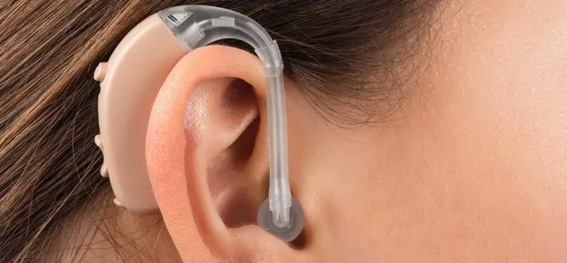 Women wear hearing device in her ear