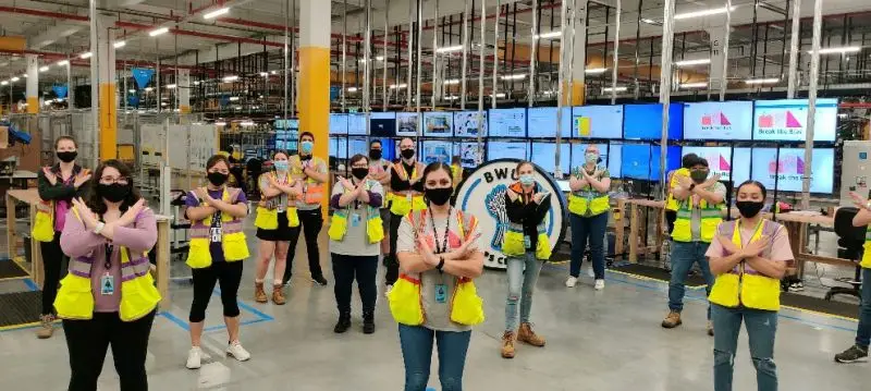 ICQA amazon workers standing for a photogrpah.