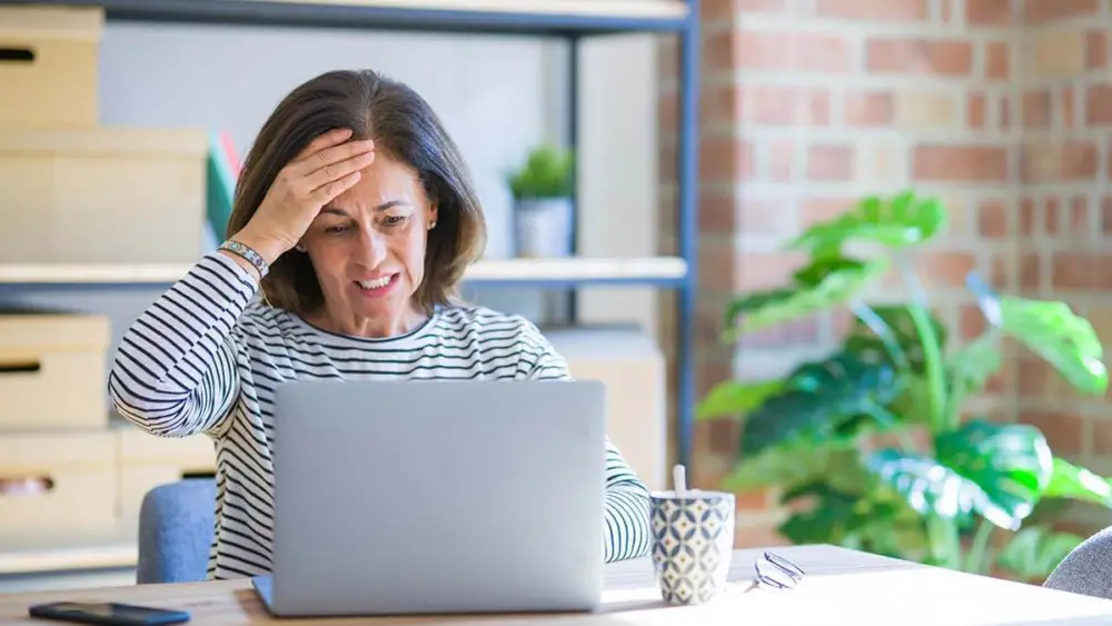 A women getting headache during working from laptop